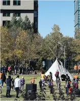  ??  ?? Students admire their handiwork after erecting a teepee on the University of Regina campus.