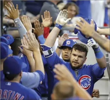  ?? AP photo ?? The Cubs’ Kyle Schwarber is greeted in the dugout after his two-run homer in the fourth inning of a 6-3 victory over the White Sox on Thursday.