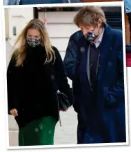  ??  ?? NICE FUR SOME: Kate, above with daughter Lila Grace, and left, with boyfriend Nikolai von Bismarck, in Paris. Right: The supermodel looked stylish in a British racing green skirt