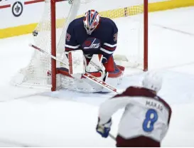  ?? John Woods, Canadian Press ?? Colorado’s Cale Makar scores against Winnipeg Jets goaltender Connor Hellebuyck in overtime Friday.