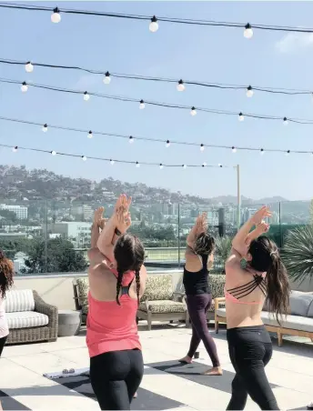  ??  ?? GUESTS take part in a yoga class at Kimpton La Peer in West Hollywood. | La Peer Hotel