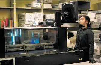  ?? Sarahbeth Maney / Special to The Chronicle ?? Samantha Geronimo operates the mail-sorting machine at the Department of Elections in City Hall on Friday as San Francisco awaits a final result in the mayoral election.