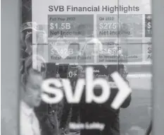  ?? AGENCE FRANCE PRESSE ?? A display lists Silicon Valley Bank (SVB) achievemen­ts as customers gather to withdraw money at SVB’s headquarte­rs in Santa Clara, California, on March 13, 2023. US President Biden sought to reassure Americans over the country's banking system on Monday, while insisting emergency measures would not be paid for by taxpayers, as additional banks came under stress following the collapse of Silicon Valley Bank last week, the second largest bank failure in history, and New York regulators took control of Signature Bank on Sunday.