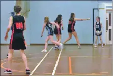  ??  ?? Goal attacker Freya McNicol disrupts an opposition pass, left, and Arran players have a go at goal.