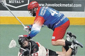  ?? CLIFFORD SKARSTEDT EXAMINER ?? Peterborou­gh Century 21 Lakers’ Chad Tutton hurdles over Brooklin Redmen’s Ryan MacSpayden during first period Major Series Lacrosse action Memorial Centre on June 14 at the Memorial Centre .