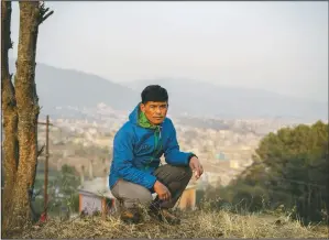  ?? (AP/Niranjan Shrestha) ?? Mountain guide Pasang Rinzee Sherpa, 33, poses for a photograph in Kathmandu, Nepal. Sherpa has scaled Mount Everest twice and spent 18 years helping climbers up the highest Himalayan peaks, generally earning about $8,000 a year. In the past 12 months, he had no income.