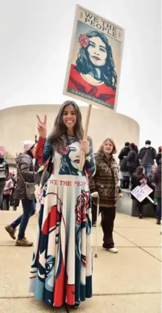  ?? MIKE COPPOLA/GETTY IMAGES ?? A protester recalls the U.S. Constituti­on to make her point in Washington.