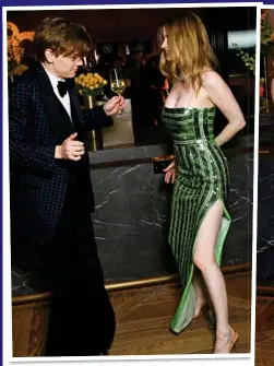  ?? ?? NEVER MIND THE BOLLYS: Pistols star Brodie-Sangster clutches his champagne while dancing with girlfriend Talulah