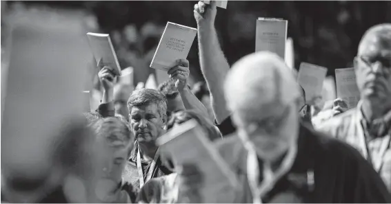  ?? Photos by Jon Shapley / Staff photograph­er ?? Bill Golden and thousands of others hold up copies of a training handbook related to sexual abuse within Southern Baptist churches.