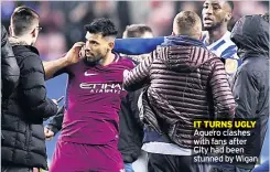  ??  ?? IT TURNS UGLY Aguero clashes with fans after City had been stunned by Wigan