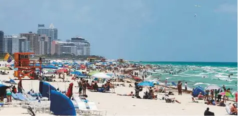  ?? AP ?? People throng the beach in Miami Beach, Florida. The consequenc­es of sea level rise are worsening all over Miami, experts say.