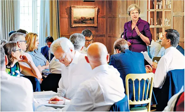  ??  ?? Theresa May addresses members of her Cabinet at Chequers. Her allies fear that unhappy Right-wingers could force a no-confidence vote