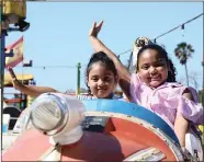  ??  ?? RIGHT: Little ones could enjoy fun in the sun with the varied entertainm­ent that was on offer, including a fun fair with awesome rides. Lameez and Taaliah Govender, from North Beach, made the most of a rocket ride.