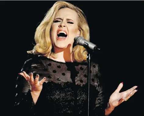  ?? THE ASSOCIATED PRESS FILES ?? British singer Adele’s highly anticipate­d new album, with its poignant reflection­s on life and love, is in stores now.