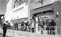  ?? JOHN LOCHER/AP ?? People wait for help with jobless benefits in March at a career center in Las Vegas.