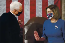  ?? ERIN SCHAFF — THE NEW YORK TIMES ?? Speaker of the House Nancy Pelosi, D-Calif., and Vice President Mike Pence talk Wednesday as a joint session of the House and Senate convenes to count the Electoral College votes cast in November’s election at the Capitol in Washington.