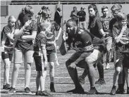  ?? Frank Augstein / Associated Press ?? The Bears’ Akiem Hicks coaches a young group during an NFL clinic in London on Wednesday.