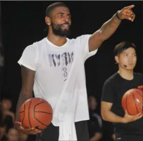  ?? CHIANG YING-YING —ASSOCIATED PRESS ?? Cavs guard Kyrie Irving holds a camp in Taiwan on July 22.