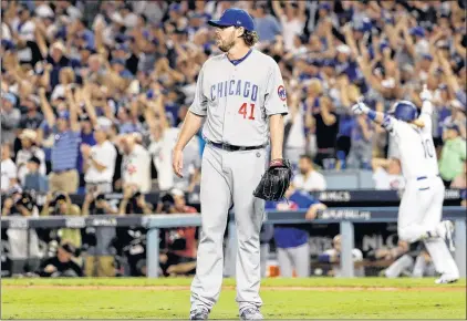  ?? AP PHOTO ?? Los Angeles Dodgers’ Justin Turner celebrates after a three-run walk off home run off Chicago Cubs starting pitcher John Lackey during the ninth inning of Game 2 of the National League Championsh­ip Series in Los Angeles on Sunday.