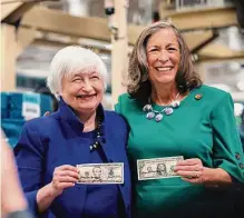  ?? Adam Perez/new York Times ?? Treasury Secretary Janet Yellen, left, and Lynn Malerba, the treasurer of the United States, hold some of the first banknotes bearing their signatures. The bills go into circulatio­n next year.