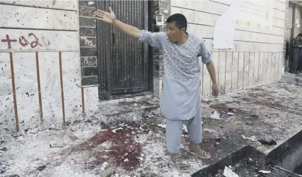  ?? PHOTOGRAPH: AP ?? 0 An Afghan shouts in anger outside the voter registrati­on centre which was attacked by a suicide bomber in Kabul yesterday afternoon.