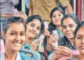  ??  ?? Women show their 'pink tickets' while travelling on a DTC bus in Delhi on Tuesday, the day the scheme was launched in the national capital.
PTI