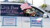  ?? SAM NAVARRO Special to the Miami Herald ?? A man in an SUV waves a flag during a Nicaraguan­s for Biden caravan as they exit Ruben Dario Park on Sept. 26.