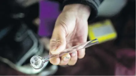  ?? DAX MELMER ?? Melissa Smith, who is homeless, pulls a crystal meth pipe out of her bag. She says “people are losing their minds” from smoking, snorting or injecting the street drug that’s laced with chemicals found in paint thinners, batteries, antifreeze and drain cleaners. “It’s killing people.” she says.