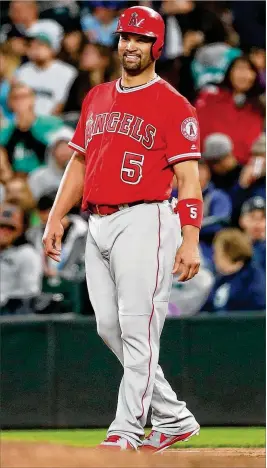 ?? ABBIE PARR / GETTY IMAGES ?? Angels first baseman/designated hitter Albert Pujols smiles after hitting a broken-bat single in the fifth inning against the Mariners to reach 3,000 career hits Friday.