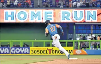  ?? ERIC ESPADA/GETTY IMAGES ?? Miami’s Giancarlo Stanton — wearing his players’ weekend jersey with his chosen nickname, “Cruz” — rounds second base after hitting his 50th home run of the season against the San Diego Padres, on Sunday, in Miami.