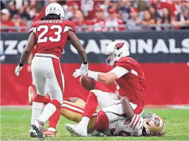  ?? MICHAEL CHOW/ AZCENTRAL SPORTS ?? Cardinals quarterbac­k Carson Palmer is sacked by 49ers linebacker Ray-Ray Armstrong at University of Phoenix Stadium in Glendale on Sunday.