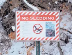  ?? GREG SORBER/JOURNAL ?? “No Sledding” signs are posted at numerous popular areas in the Cibola National Forest’s Sandia Ranger District along state Highway 536, also known as Sandia Crest Highway.