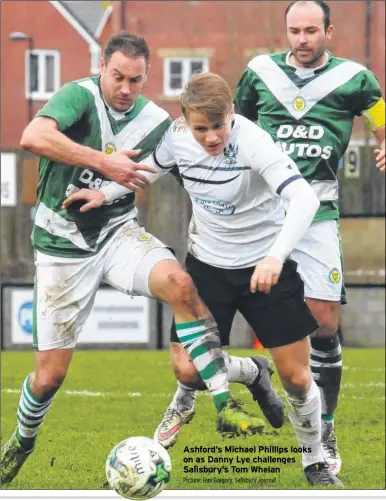  ?? Picture: Tom Gregory, Salisbury Journal ?? Ashford’s Michael Phillips looks on as Danny Lye challenges Salisbury’s Tom Whelan