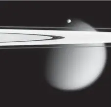  ?? NASA/THE ASSOCIATED PRESS FILE PHOTO ?? This image, made by the Cassini spacecraft, shows two of Saturn’s moons, the small Epimetheus and Titan, with Saturn’s A and F rings.