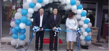  ??  ?? (From right) Hii, Ho and Lau cut the ribbon together to launch the newly-upgraded Syarikat JL Motors’ 3S One-Stop Proton Centre in Piasau.