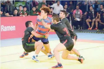  ?? — AFP ?? Korea’s Dong Geopn Lee tries to break a cordon by Iran’s players during the semifinal match between Iran and Korea of the 2016 Kabaddi World Cup at the Transstadi­a in Ahmedabad on Friday.