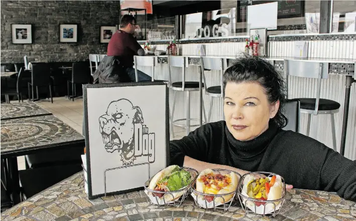  ?? LARRY WONG/EDMONTON JOURNAL ?? Brenda Dutton, co-owner of a new restaurant named The Dog, serves gourmet hotdogs and other fun, delectable treats in a casual little spot at 9567 118th Ave.