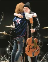  ?? EUGENE HOSHIKO/AP ?? Randy Bachman, right, and Takeshi embrace after Bachman was reunited with his stolen Gretsch guitar Friday at the Canadian Embassy in Tokyo.