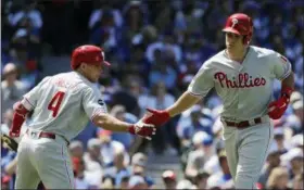  ?? NAM Y. HUH — THE ASSOCIATED PRESS ?? Phillies’ J.T. Realmuto, right, celebrates with Scott Kingery after hitting a solo home run against the Cubs.