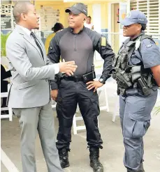  ?? PHOTOS BY CHRISTOPHE­R SERJU ?? Floyd Green (left), state minister for education, youth and informatio­n, interacts with members of the security forces on duty in the zone of special operations in Denham Town, west Kingston.