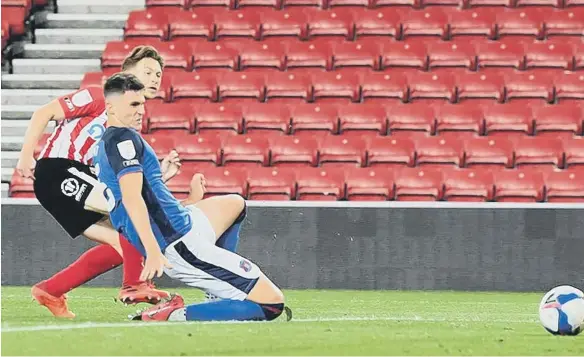  ??  ?? Denver Hume slides home Sunderland’s second goal against Carlisle United.