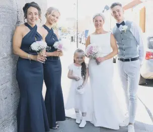  ?? ?? Kelly with her bridesmaid­s Tammy, left, and daughter Belle, flower girl niece Olivia and son Louis.