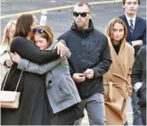  ?? JOHN CARL D’ANNIBALE/THE ALBANY TIMES UNION VIA AP ?? Mourners leave St. Stanislaus Roman Catholic Church during calling hours Friday for crash victims Allison King, Abigail Jackson, Adam Jackson, Mary Dyson, Robert Dyson, Amy Steenburg, Axel Steenburg and Richard Steenburg in Amsterdam, New York.