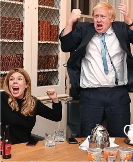 ??  ?? What a result! Boris Johnson and his partner Carrie Symonds