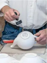  ??  ?? Left to right: Opening the spout with a sharp knife; roughening the teapot’s surface with a sponge to better apply the paint; stamping the pottery logo onto the base of the pot.