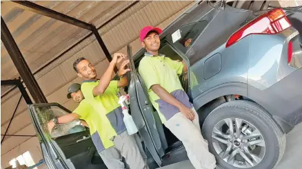  ??  ?? Tint Factory team based in Westfield, Nadi tinting a car at the workshop.