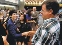  ??  ?? Papazian shakes hands with Stefan Frazier, vice chair of the SJSU academic senate, before delivering her fall welcome address. Papazian was born and raised in Southern California and studied at UCLA.