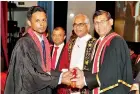  ??  ?? CA Sri Lanka President Mr. Jagath Perera conferring the ACA designatio­n to a new Chartered Accountant in the presence of State Minister of Finance Mr. Eran Wickramara­tne and Chairman of the Member Relations Committee Mr. Sanjaya Bandara.