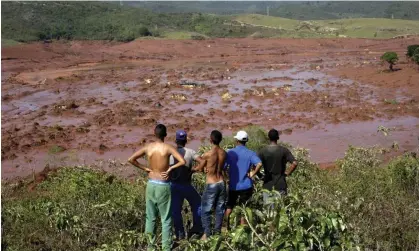  ?? ?? Observing the destructio­n caused by the collapse of the Fundão tailings dam in Mariana, Brazil, November 2015. Photograph: Ricardo Moraes/Reuters