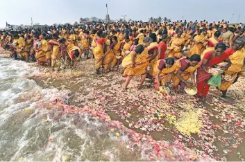  ?? — PTI ?? Women pay floral tributes to 2004 tsunami victims on its 13th anniversar­y in Chennai on Tuesday.